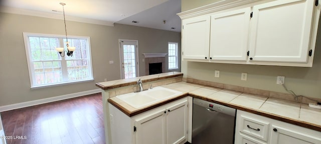 kitchen with plenty of natural light, dishwasher, a peninsula, and a sink