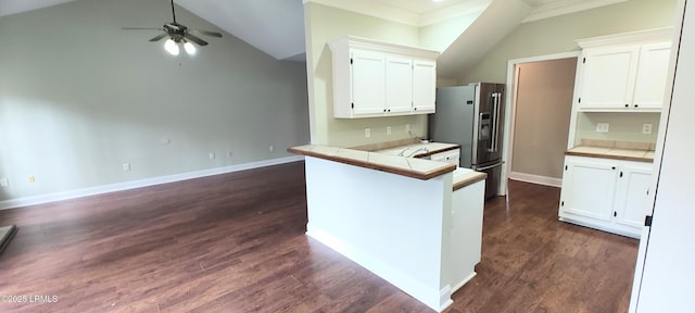 kitchen featuring dark wood-type flooring, stainless steel refrigerator with ice dispenser, white cabinetry, a peninsula, and tile counters