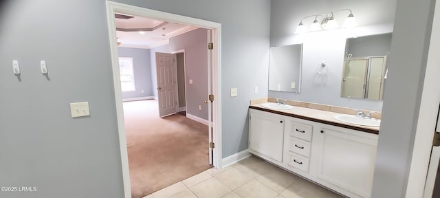 full bath featuring tile patterned flooring, double vanity, ornamental molding, and a sink