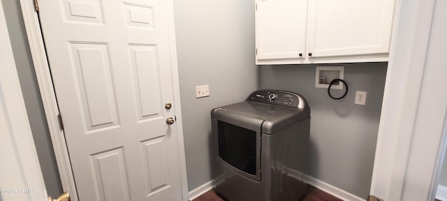 laundry area featuring washer / clothes dryer, cabinet space, and baseboards