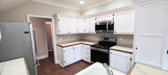 kitchen featuring tile countertops, dark wood-type flooring, appliances with stainless steel finishes, and white cabinetry