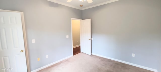 unfurnished bedroom with crown molding, carpet flooring, and baseboards