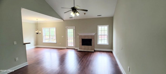 unfurnished living room featuring visible vents, a ceiling fan, dark wood-style floors, baseboards, and a tile fireplace