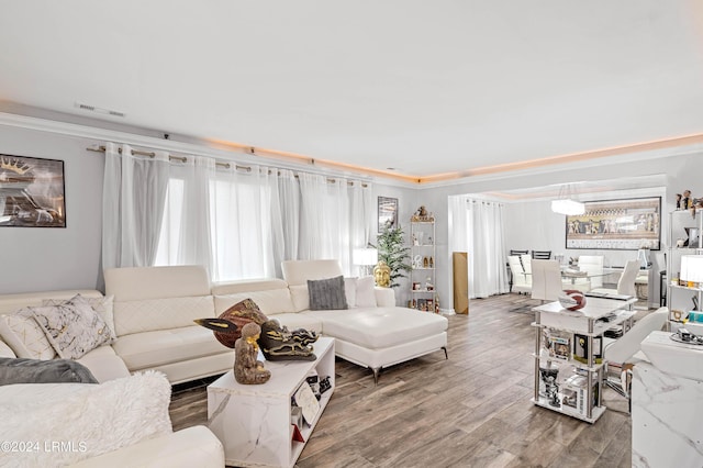 living room with crown molding and hardwood / wood-style floors