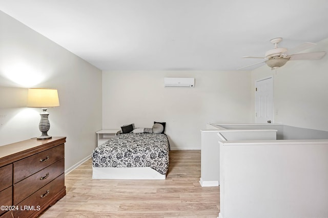 bedroom featuring an AC wall unit, light wood-type flooring, and ceiling fan