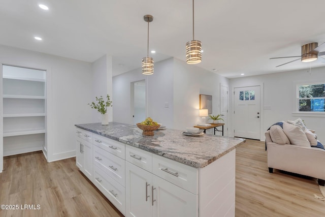 3001 N St, Beaufort, SC 29902 - kitchen with open floor plan, light wood-style flooring, a center island, light stone countertops, and white cabinets