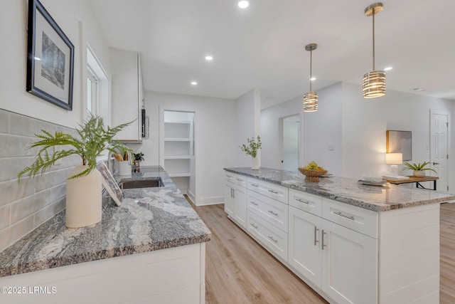 3001 N St, Beaufort, SC 29902 - kitchen with a sink, light wood finished floors, light stone counters, a kitchen island, and recessed lighting