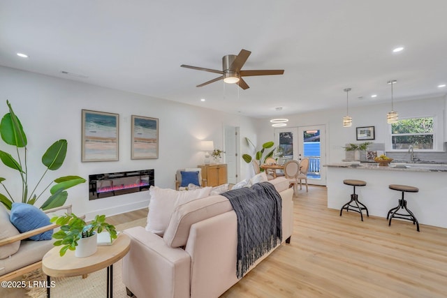 3001 N St, Beaufort, SC 29902 - living area featuring light wood-type flooring, recessed lighting, ceiling fan, and a glass covered fireplace