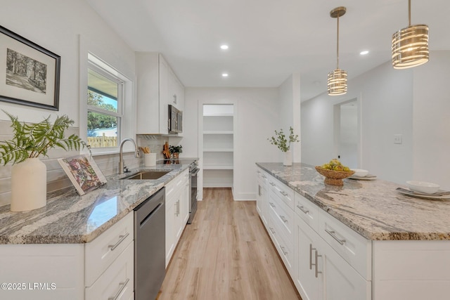 3001 N St, Beaufort, SC 29902 - kitchen featuring stainless steel appliances, light wood finished floors, a sink, recessed lighting, and light stone countertops