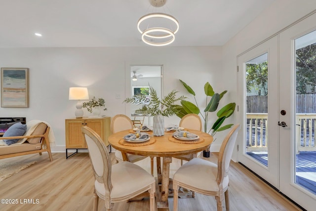 3001 N St, Beaufort, SC 29902 - dining area with french doors, light wood finished floors, baseboards, and a chandelier