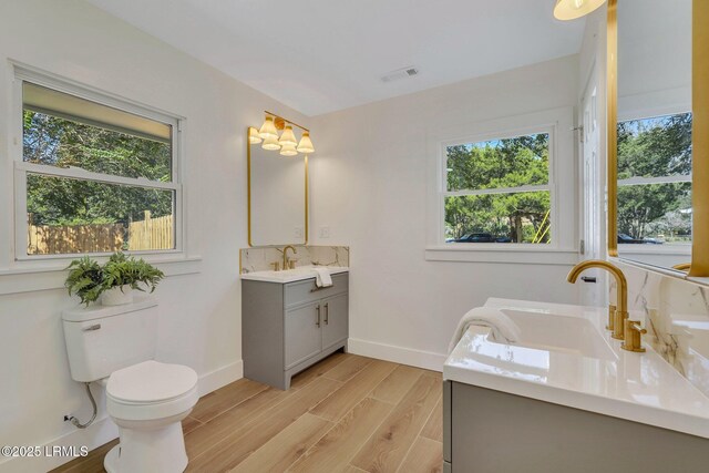 3001 N St, Beaufort, SC 29902 - bathroom featuring vanity, baseboards, toilet, and wood finished floors