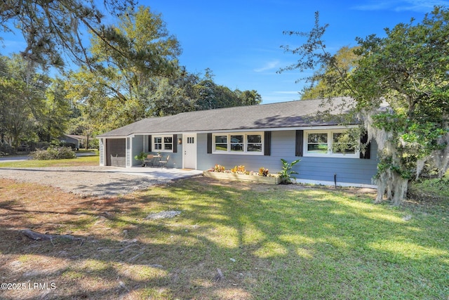 3001 N St, Beaufort, SC 29902 - ranch-style house featuring a front lawn, a garage, a shingled roof, and driveway