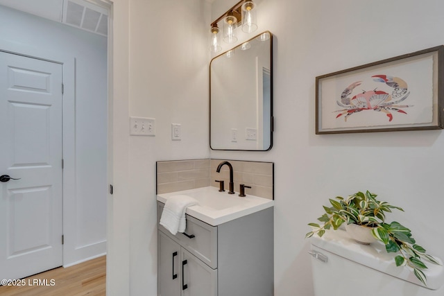 3001 N St, Beaufort, SC 29902 - bathroom with tasteful backsplash, vanity, wood finished floors, and toilet
