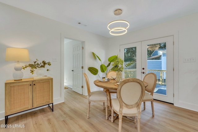 3001 N St, Beaufort, SC 29902 - dining room with light wood finished floors, a chandelier, and baseboards