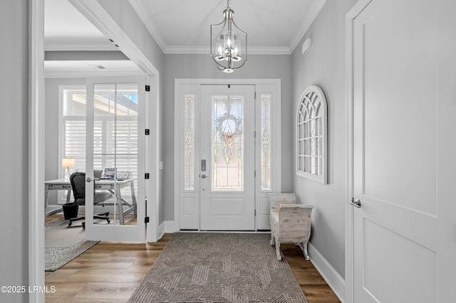 327 River Oak Way, Hardeeville, SC 29927 - entryway with a chandelier, wood finished floors, and ornamental molding