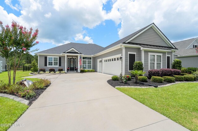 327 River Oak Way, Hardeeville, SC 29927 - single story home featuring a garage, driveway, and a standing seam roof