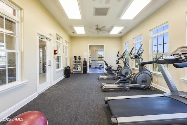 workout area with visible vents, a ceiling fan, baseboards, and french doors
