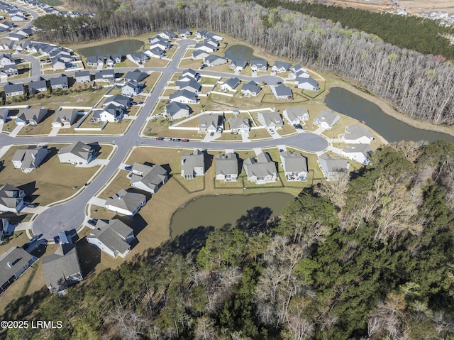 birds eye view of property with a water view, a view of trees, and a residential view