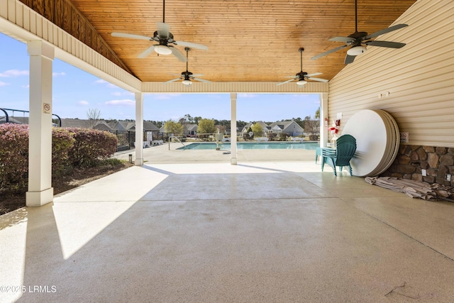 view of patio / terrace with ceiling fan and an outdoor pool