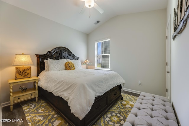 bedroom with baseboards, lofted ceiling, wood finished floors, and visible vents