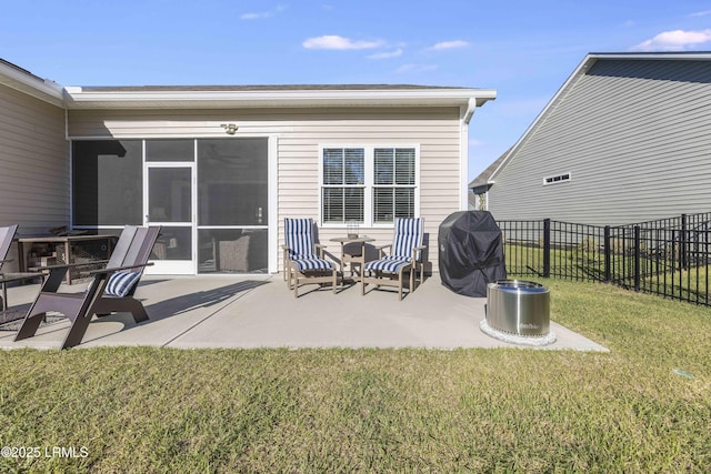 view of patio featuring fence, a sunroom, and a grill