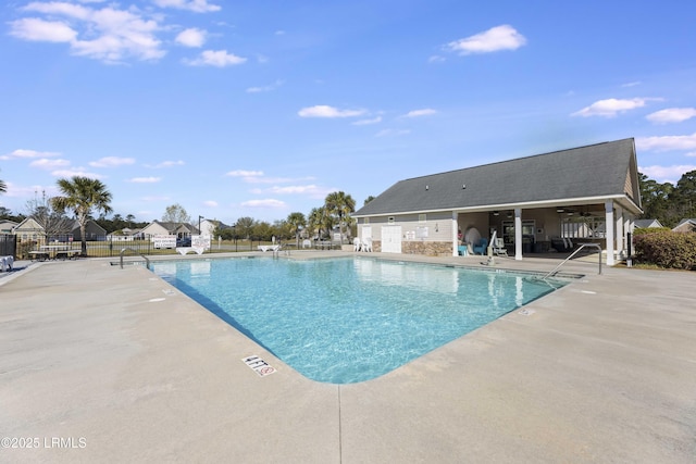 community pool featuring a patio, ceiling fan, and fence