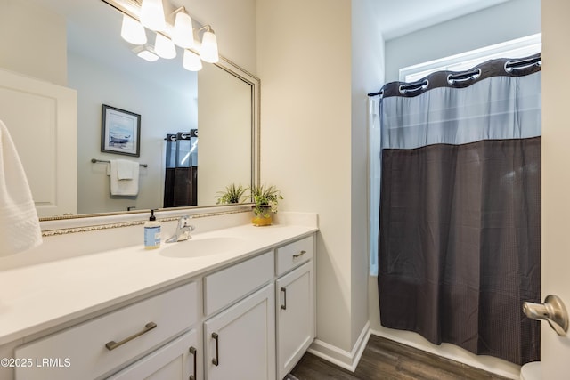 full bath featuring vanity and wood finished floors
