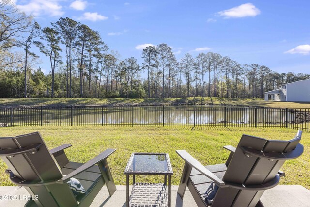 view of yard featuring fence and a water view