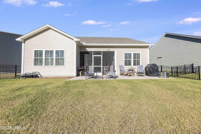 back of house featuring a sunroom, a fenced backyard, a lawn, and a patio area