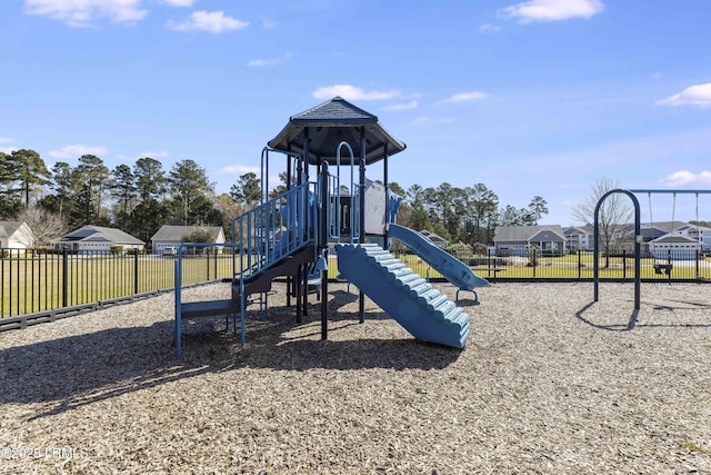 community play area featuring fence and a residential view