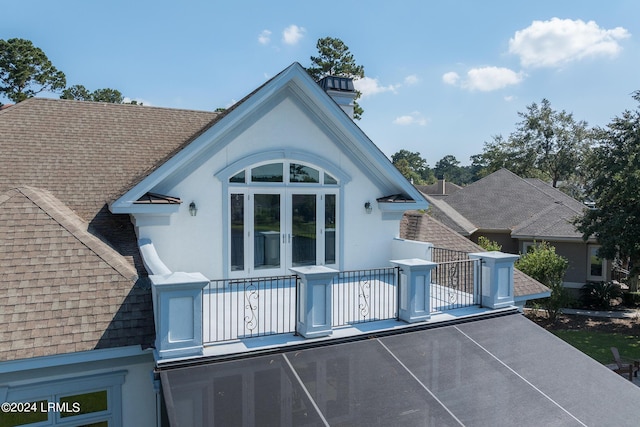 back of property featuring a balcony