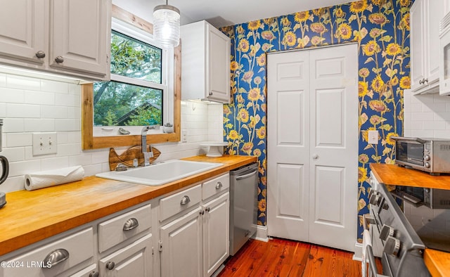 kitchen featuring white cabinetry, sink, wooden counters, and appliances with stainless steel finishes