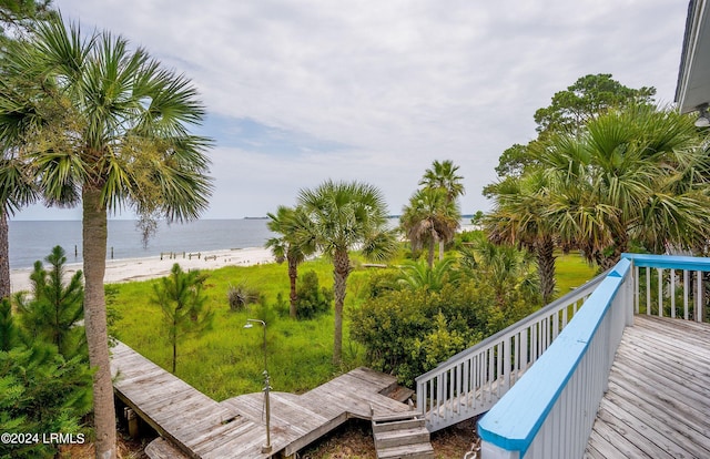 deck featuring a beach view and a water view