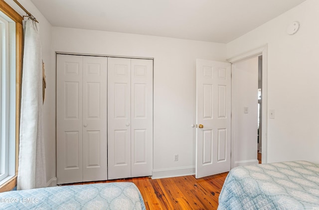 bedroom featuring a closet and light wood-type flooring