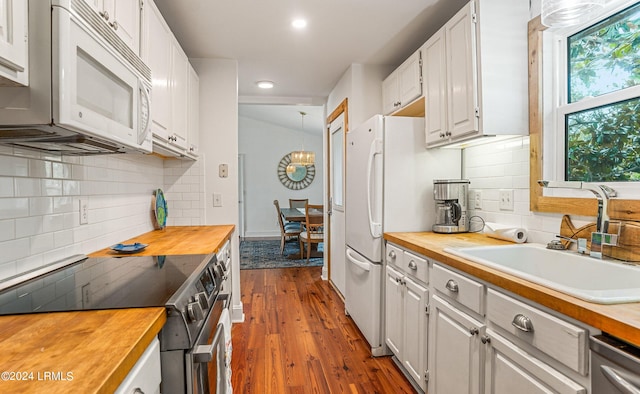 kitchen featuring butcher block countertops, sink, hardwood / wood-style floors, stainless steel appliances, and white cabinets