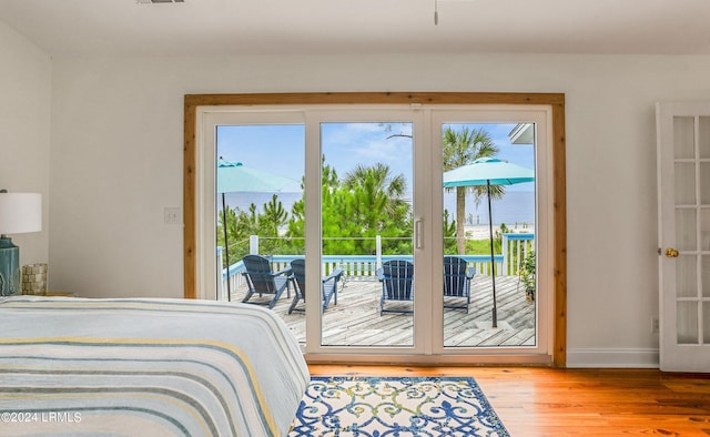 bedroom with hardwood / wood-style flooring and access to exterior