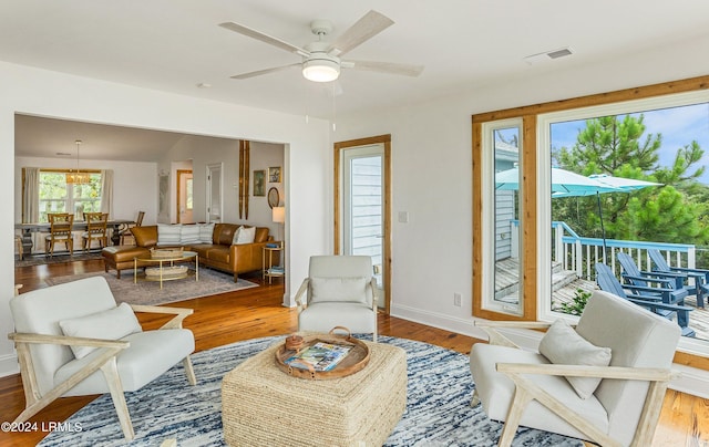 living room featuring hardwood / wood-style floors and ceiling fan