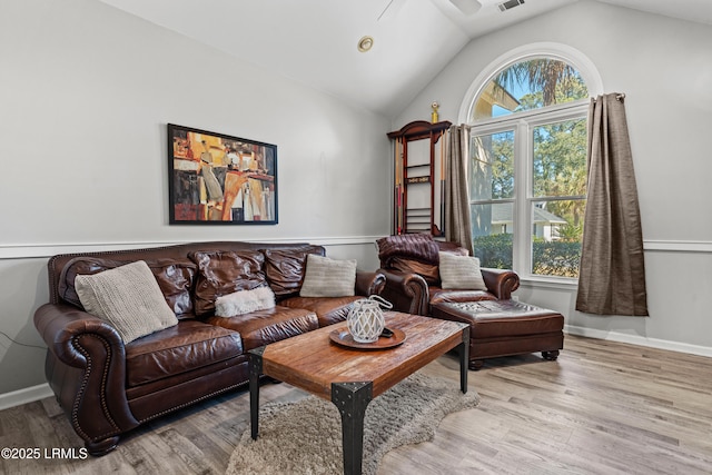 living room with vaulted ceiling and light hardwood / wood-style floors