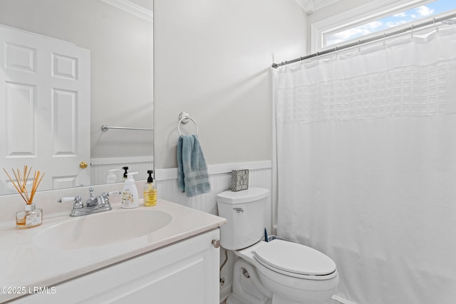 bathroom with vanity, crown molding, curtained shower, and toilet