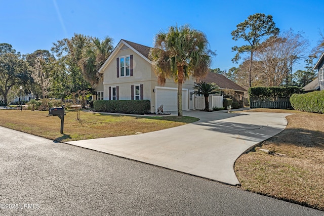 view of front of house with a garage and a front yard