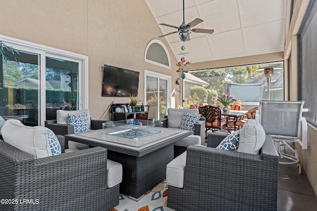 sunroom featuring ceiling fan