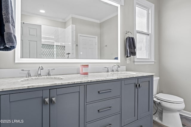 bathroom with hardwood / wood-style flooring, vanity, ornamental molding, toilet, and walk in shower