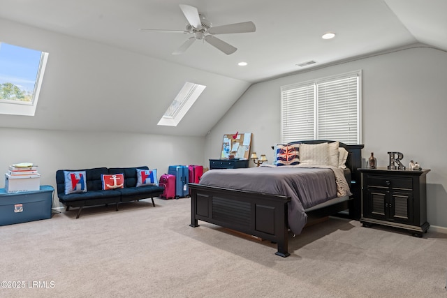 bedroom with ceiling fan, lofted ceiling with skylight, and light carpet