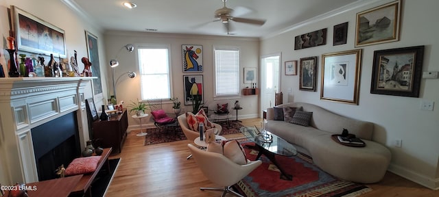 45 Holbrook Dr, Beaufort, SC 29902 - living room with a fireplace, crown molding, light wood-type flooring, and ceiling fan