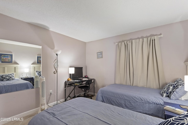 bedroom featuring carpet floors and a textured ceiling