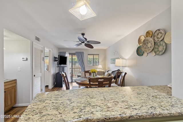 dining area featuring hardwood / wood-style floors and ceiling fan