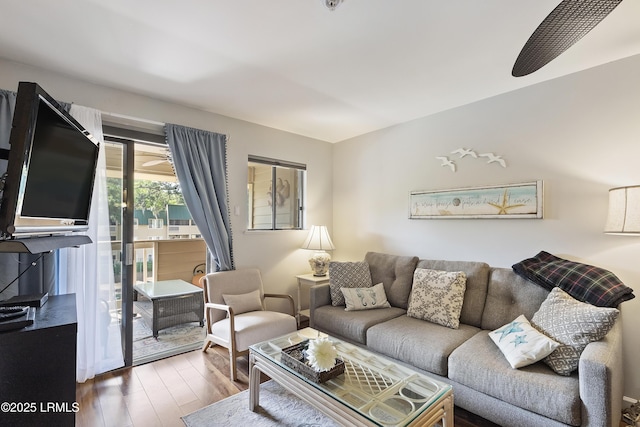 living room with hardwood / wood-style flooring and ceiling fan