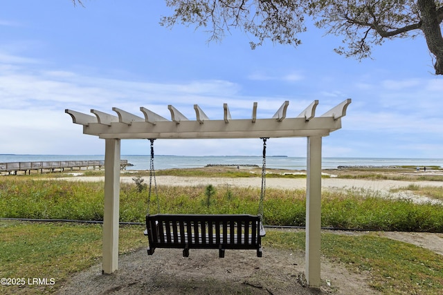 view of home's community featuring a beach view and a water view