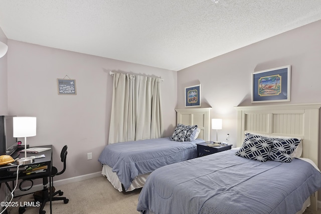 bedroom featuring light colored carpet and a textured ceiling