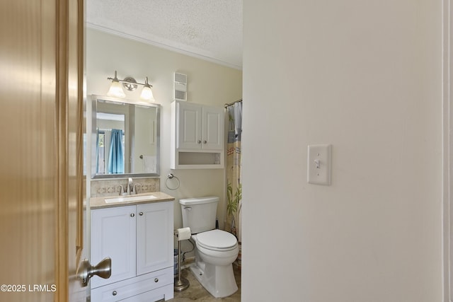 bathroom with vanity, a textured ceiling, and toilet